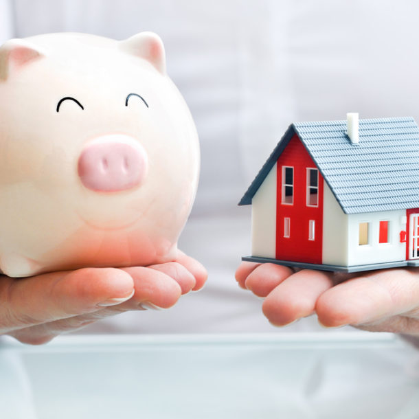 Estate Planning Lawyer - Hands holding a piggy bank and a house model