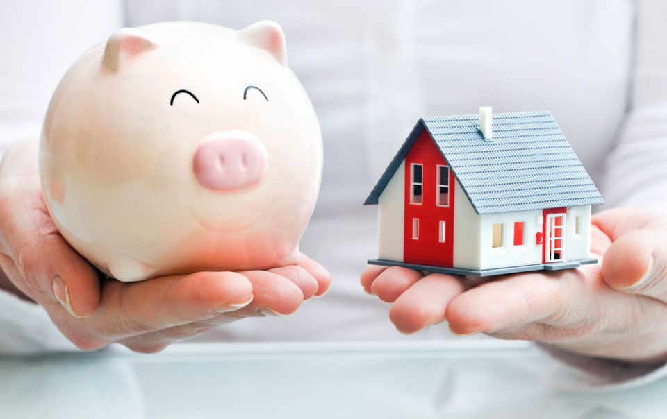 Estate Planning Lawyer - Hands holding a piggy bank and a house model