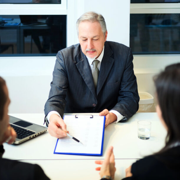 A couple sits down and talks with a tax attorney