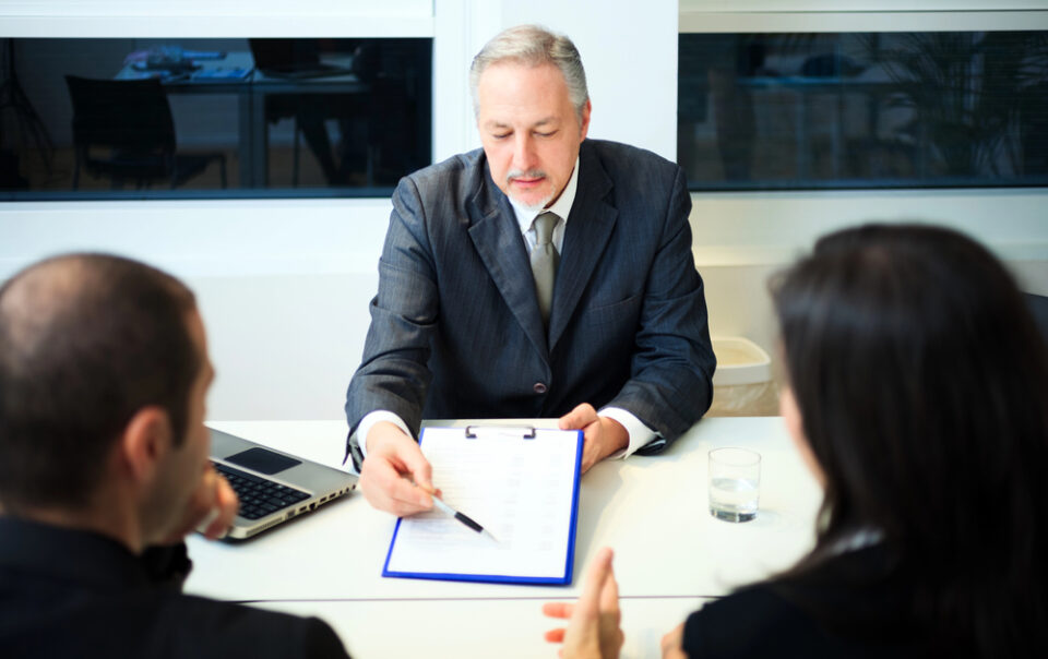 A couple sits down and talks with a tax attorney