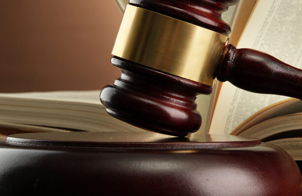 Gavel on the desk of an estate planning lawyer in front of an open law book