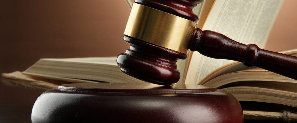 Gavel on the desk of an estate planning lawyer in front of an open law book